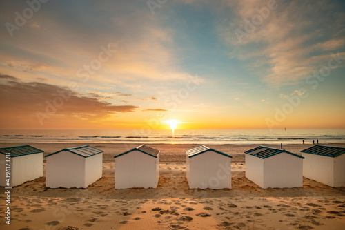 Beachhouses at the beach on Texel island in the Netherlands during sun set. photo