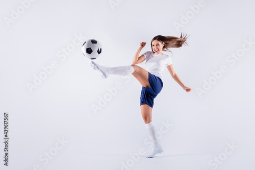 Full length body size view of nice attractive lovely crazy slim sportive cheerful strong straight-haired girl jumping playing kicking ball isolated on light white gray pastel color background © deagreez