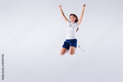 Full length body size view of nice attractive lovely crazy energetic overjoyed cheerful cheery straight-haired girl jumping having fun rejoicing isolated on light white gray pastel color background