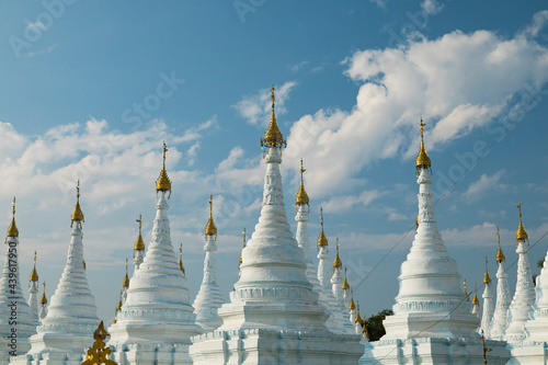 Cityscape of clouds and white Buddhist stupas in Sanda Muni Pagoda, memorial to Mindon Min's in Mandalay, Myanmar photo