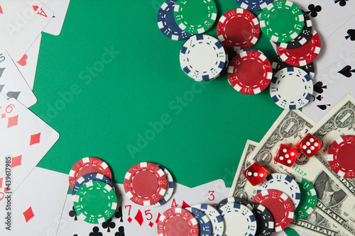 Classic playing cards, chips, red dice and dollars on green background. Gambling and casino concept.