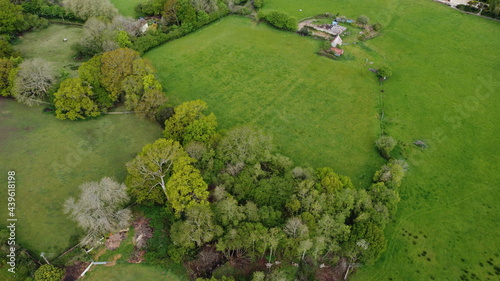 An aerial view over open countryside with hedgerows and rolling fields
