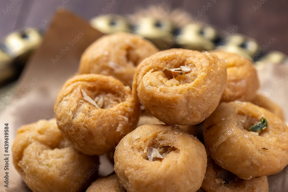 Indian traditional sweet balushahi served on a metal plate on wooden background Indian traditional sweet balushahi served on a metal plate on wooden background