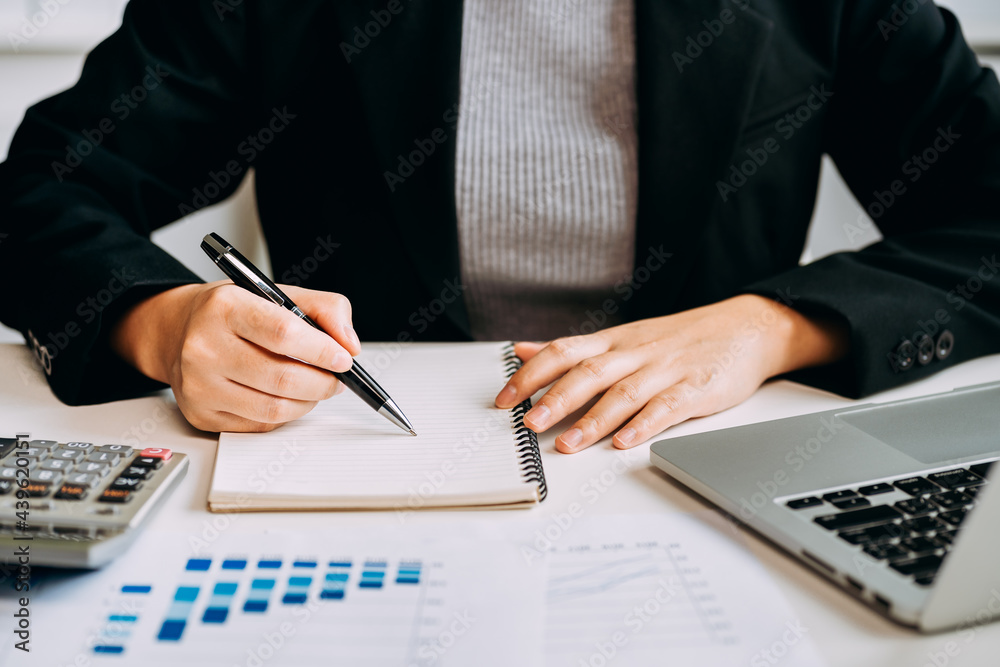 Fototapeta premium close up view of businesswomen working about accounting at the workplace, auditor, broker stock marketing, financial advisor, female investor analyze the financial statement of a business.