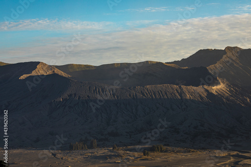 Bromo active volcano natural landscape at sunset  part of the Tengger massif  seen from Cemoro Lawang village  in East Java province  Indonesia