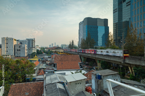 A train from the public transport of Jakarta, speeds down the tracks to the Gondangdia train station photo