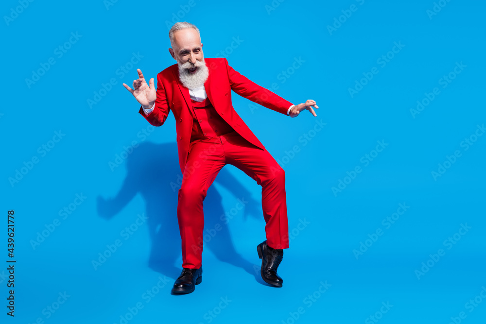 Full length photo of senior man wealthy happy positive smile have fun party wear suit isolated over blue color background Full length photo of senior man wealthy happy positive smile have fun party wear suit isolated over blue color background
