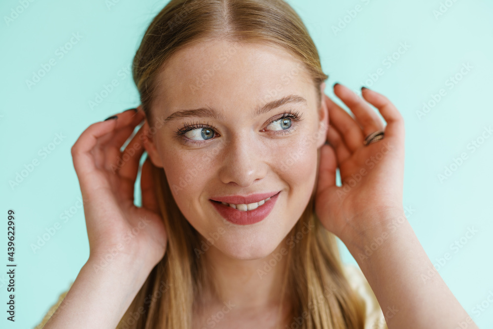 Young blonde white woman smiling and looking aside