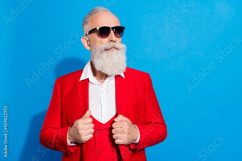 Photo of elederly rich business man serious confident wear sunglass look empty space isolated over blue color background photo