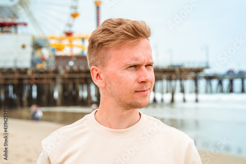 Portrait of a young blonde man on Santa Monica beach in Los Angeles