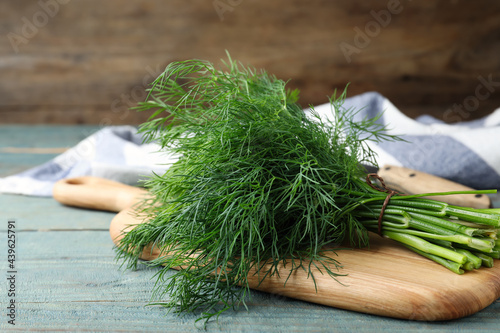 Foto Bunch of fresh dill on light blue wooden table