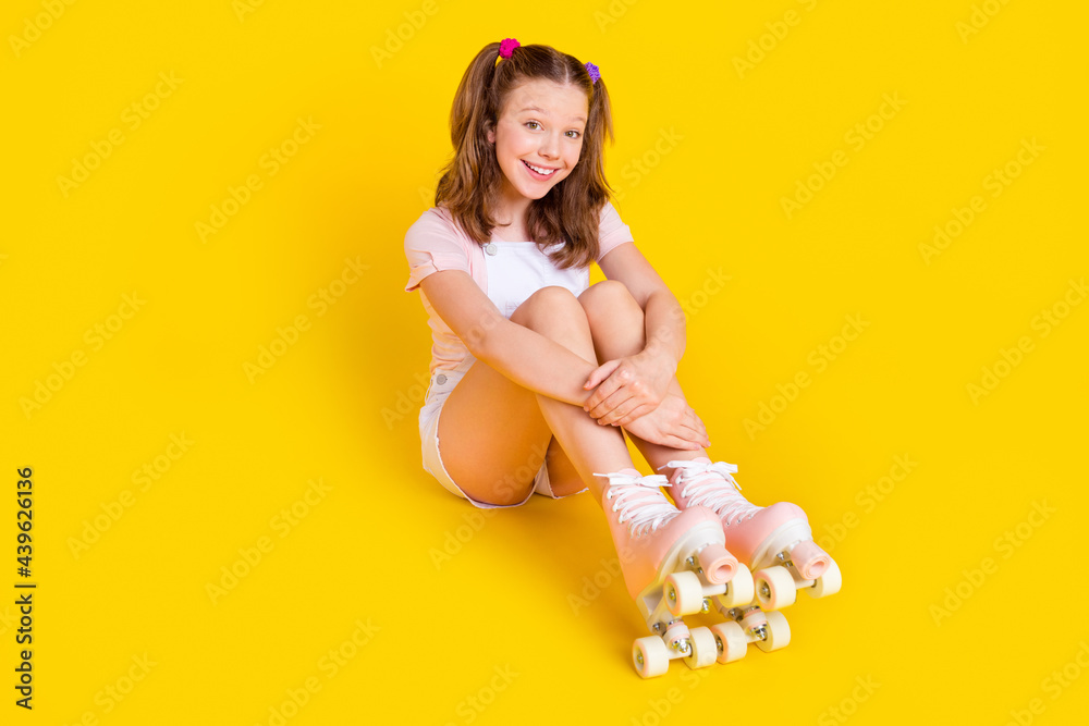 Full length body size photo schoolgirl wearing rollers smiling cheerful happy isolated bright yellow color background - obrazy, fototapety, plakaty 