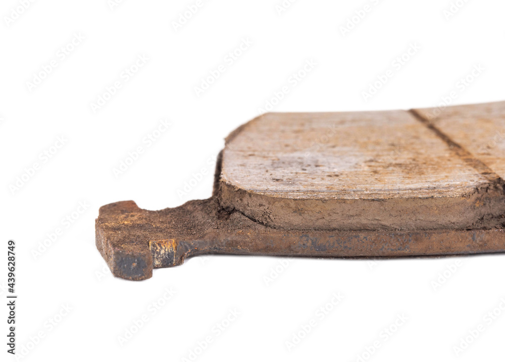 Fototapeta premium Old worn out brake pads from a car on a white background, isolate, close-up. Quality of friction linings, modern auto parts
