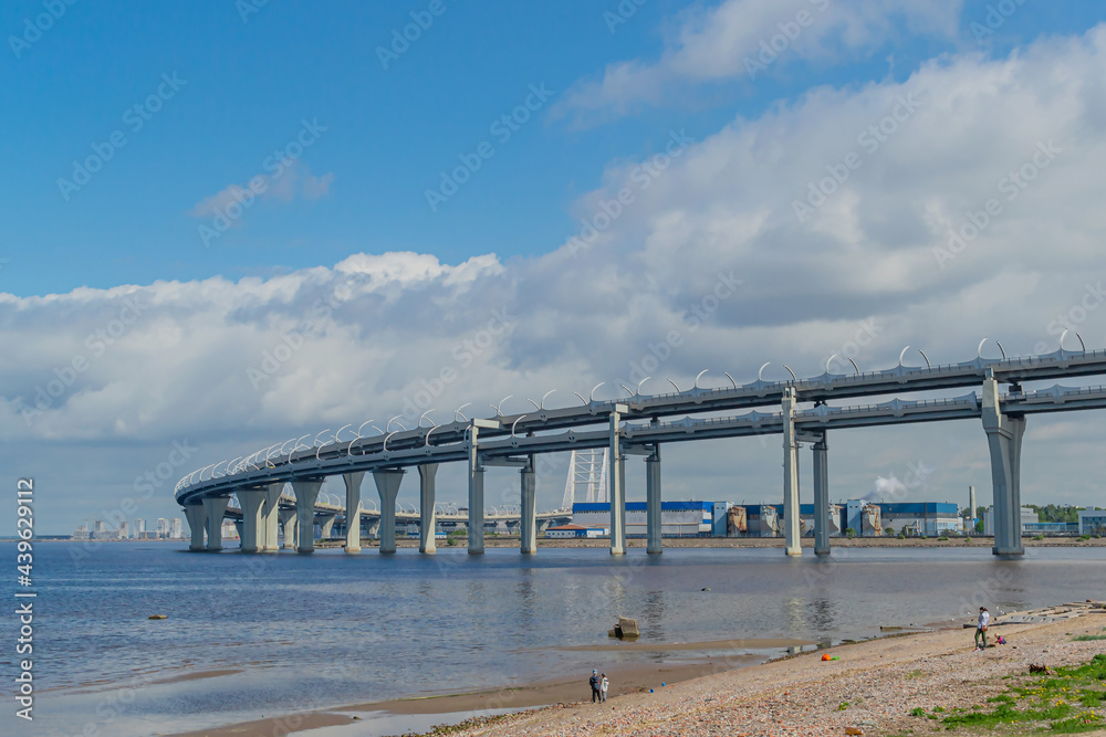 View of the rounded motorway highway bridge,the road passing over the sea bay near the coast of the city. Saint Petersburg, Europe