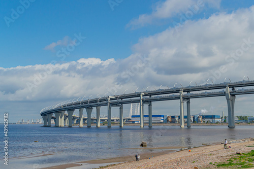 View of the rounded motorway highway bridge,the road passing over the sea bay near the coast of the city. Saint Petersburg, Europe © SymbiosisArtmedia