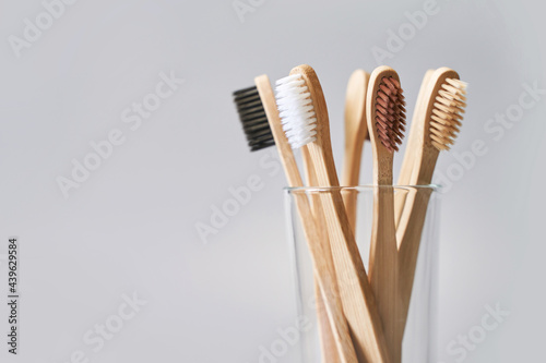 Set of ecology toothbrush on grey background. Different color at glass. Diversity concept. Sustainable mouth product. Zero waste lifestyle. Organic accessory group. Biodegradable recycle