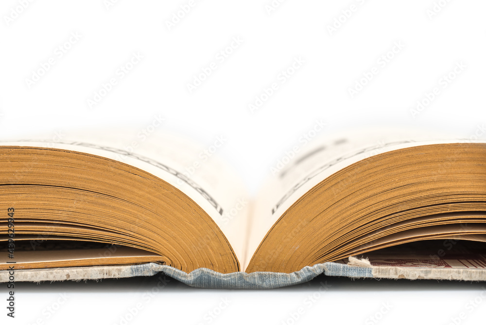 Fototapeta premium Antique opened book, side view, isolated on white background