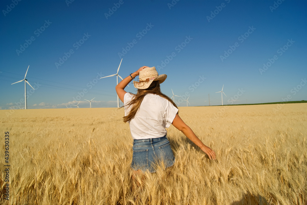 Young farmer girl working in a wheat field at summer in Spain Young farmer girl working in a wheat field at summer in Spain