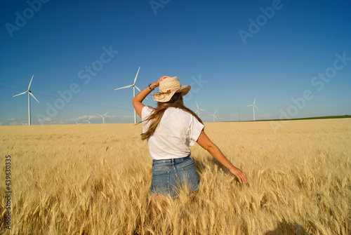 Young farmer girl working in a wheat field at summer in Spain