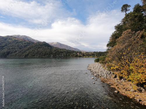 Lake Falkner in a sunny autumn day. View of the pure water, Andes mountains, shoreline and forest in San Martín de los Andes, Patagonia, Argentina. 