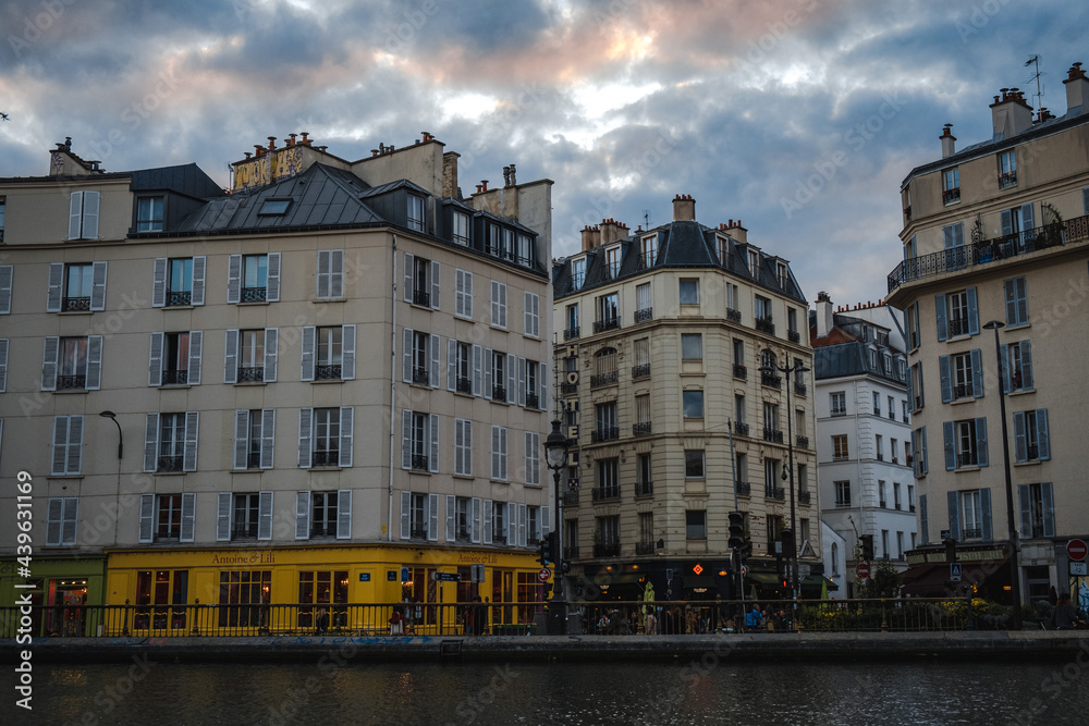 Le canal St Martin entouré par les typiques immeubles parisiens.