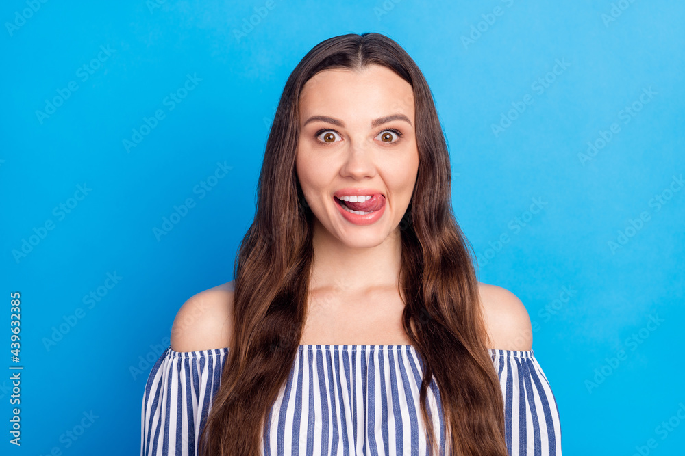Photo of sweet funny young lady wear off-shoulders clothes tongue licking lips smiling isolated blue color background Photo of sweet funny young lady wear off-shoulders clothes tongue licking lips smiling isolated blue color background