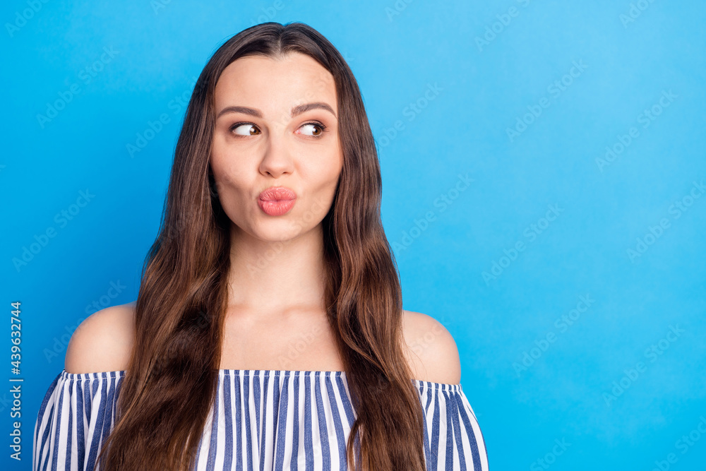 Photo of pretty adorable young lady wear off-shoulders clothes lips pouted looking empty space isolated blue color background Photo of pretty adorable young lady wear off-shoulders clothes lips pouted looking empty space isolated blue color background