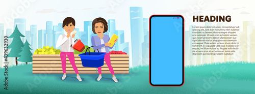 Two girls buy groceries at a street fair