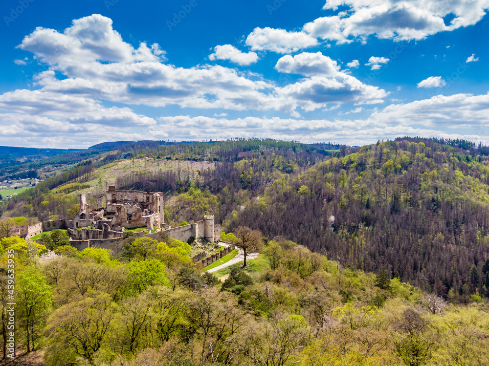 Aerial drone panorama view of medieval castle Boskovice. Ruin of ancient stronghold placed at hill in South Moravia region, Czech Republic. Summer day with blue sky.