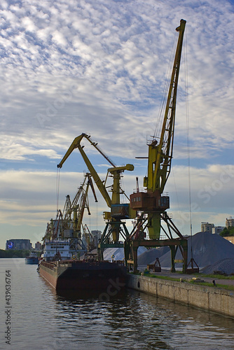 crane in the port at the loading of a barge