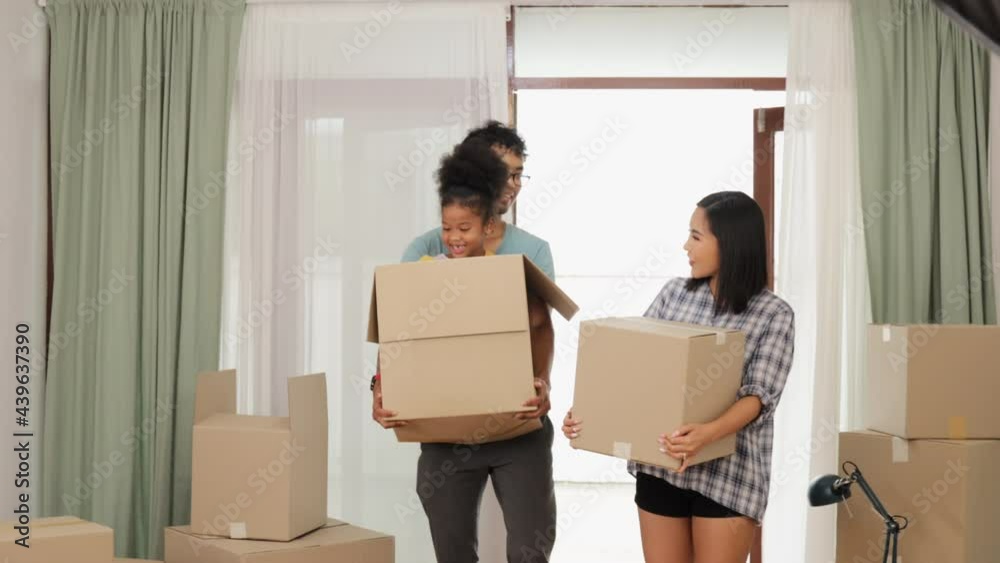 Happy asian family couple holding boxes entering new modern house.family unpacking boxes. Happy asian family couple holding boxes entering new modern house.family unpacking boxes.