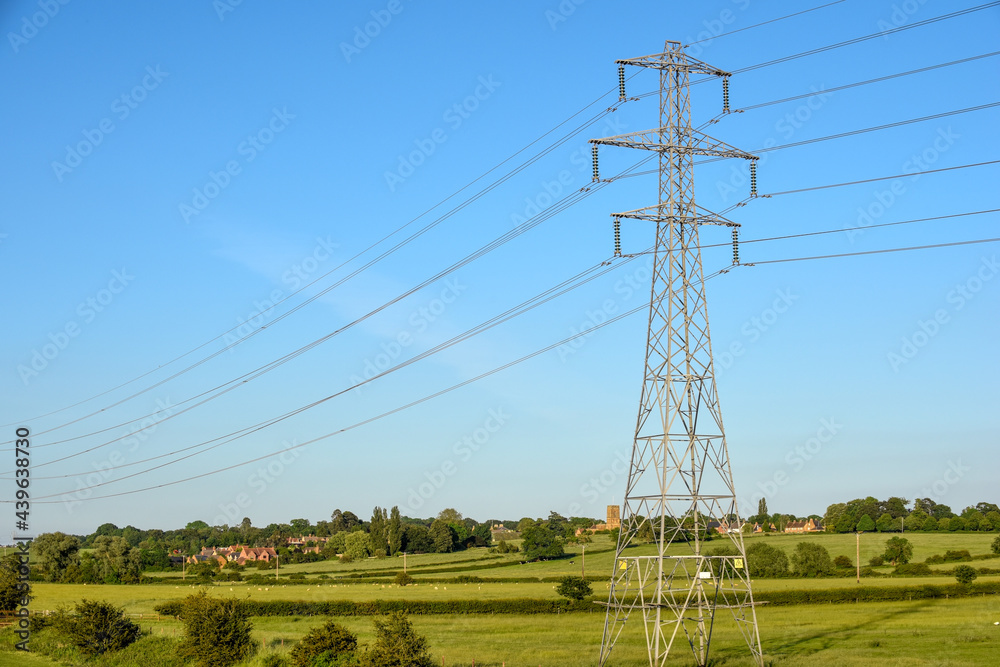 Electricity pylon tower with cables over blue sky landscape