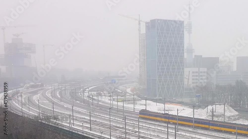 AMSTERDAM, NETHERLANDS - Jan 21, 1999: Amsterdam, Netherlands - 21st January 2019: View of trains working during heavy snow at the Amsterdam Zuid station in Netherlands photo