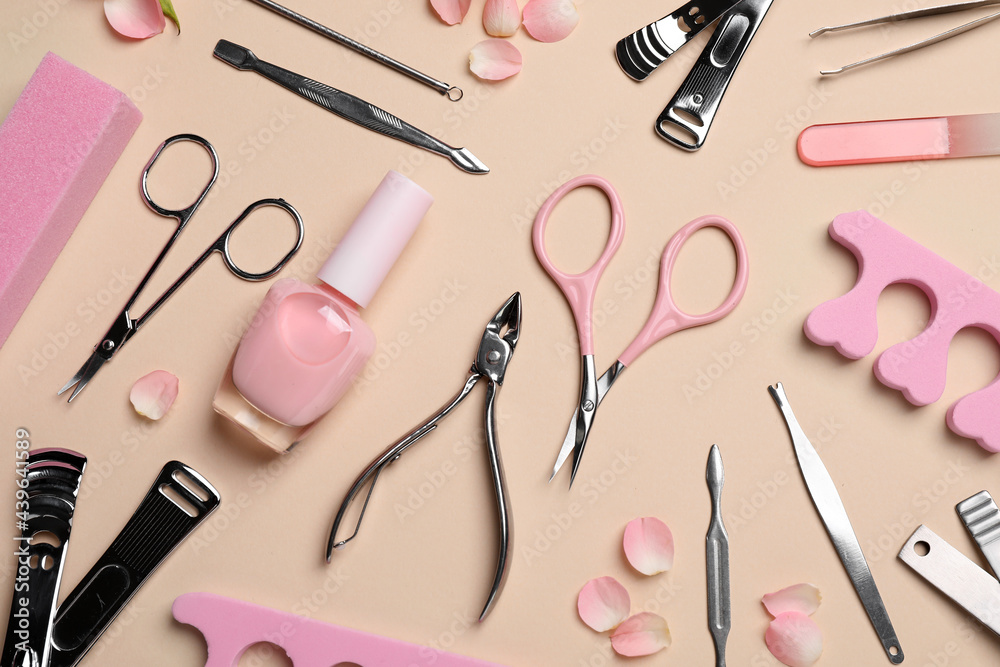 Composition with manicure and pedicure tools on beige background, flat lay Composition with manicure and pedicure tools on beige background, flat lay