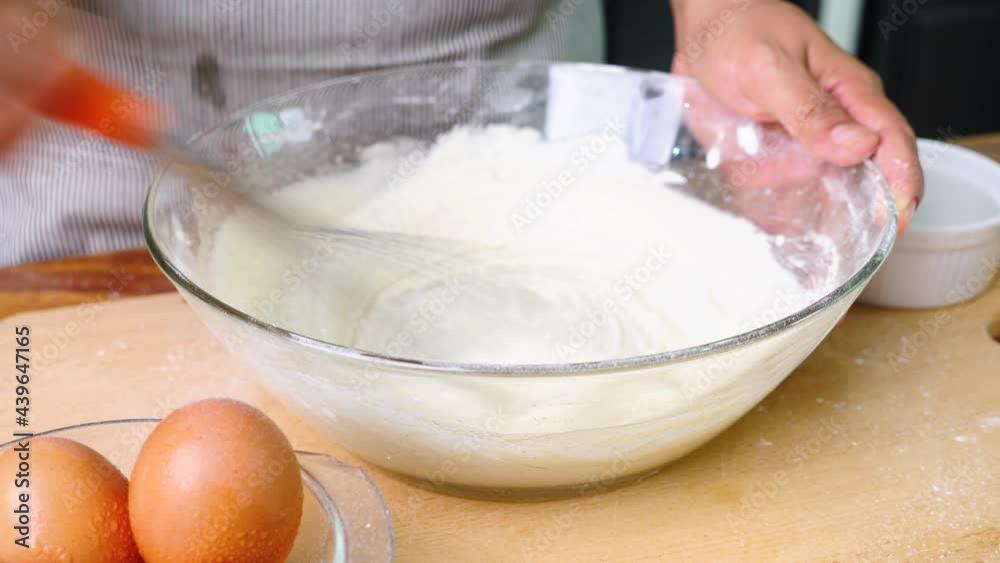 girl making cakes or cookies. She is mixing all the ingredients together. girl making cakes or cookies. She is mixing all the ingredients together.