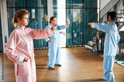 Women summoning strength during qigong physical exercises