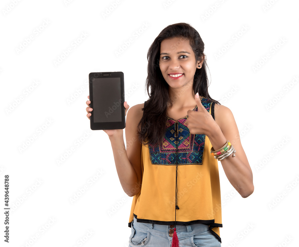 Young beautiful woman holding blank screen smart phone on white background