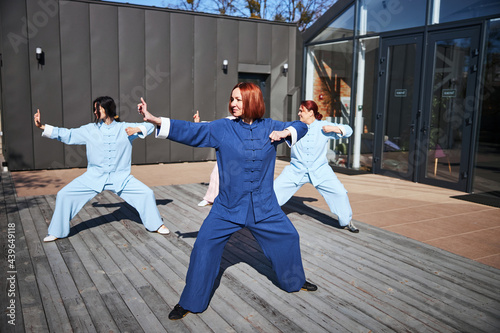 Gladsome people training for martial arts outside