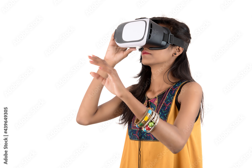 Beautiful girl looking though VR device. Young girl wearing virtual reality goggles headset. Beautiful girl looking though VR device. Young girl wearing virtual reality goggles headset.