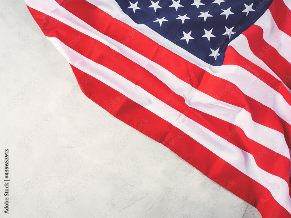 Fototapeta premium American stars and stripes flag on gray concrete background