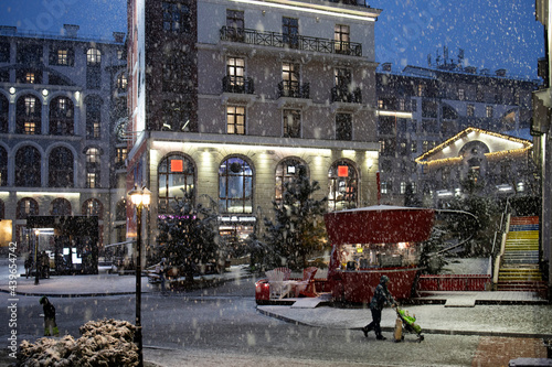 Modern city street during heavy snowfall photo