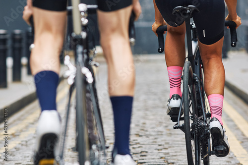 Cycling Male athlete cyclist adjusts bike socks before entering road race