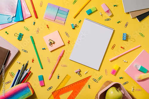 Education and freelancer work concept. School supplies, stationery accessories on yellow background. Flat lay, top view. Copy space
