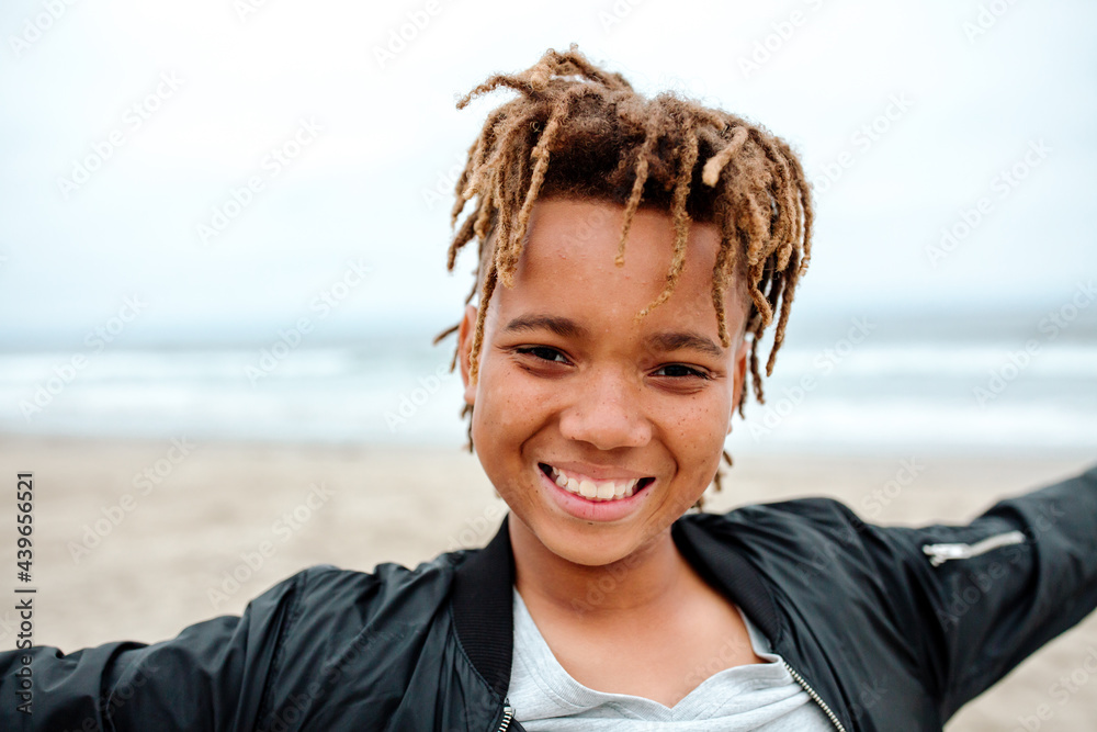 Happy teen boy with dreadlocks at the beach Happy teen boy with dreadlocks at the beach