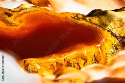 Abstract landscape of yellow rocks in river water photo