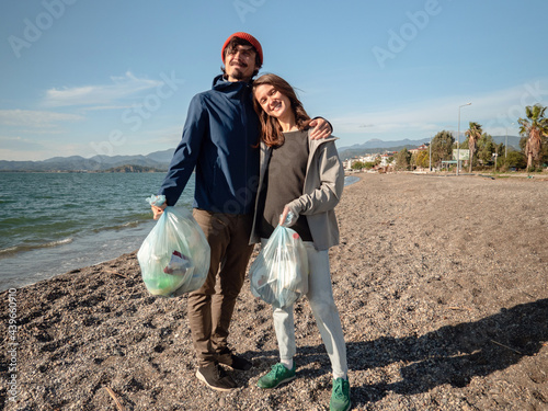 Collecting garbage on the beach photo