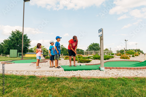 Leisure game of miniature golf at the park. 