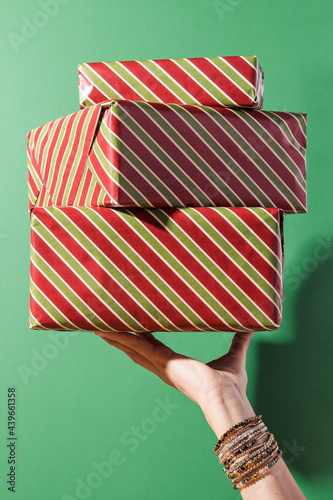 Woman's hand holding a pile of presents photo