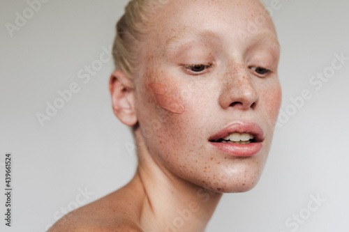 Freckled model with clay mask photo