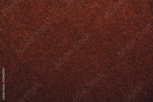 A close up of brown felt material background. Textured fabric backdrop. Copy space